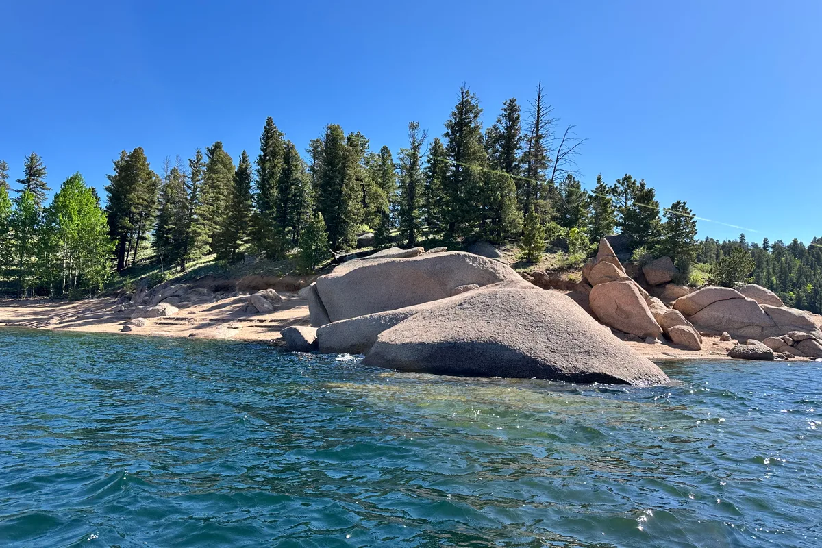 Rocky shoreline with ponderosa pines at Rampart Reservoir